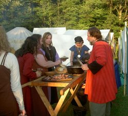 Brogan serves the guests on feast night at Pennsic XXXV<br />Image submitted by Guthrum